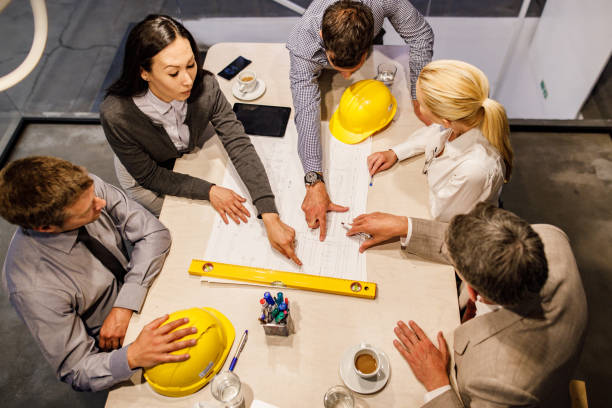 istock Above view of team of architects analyzing blueprints in the office. 1226389993