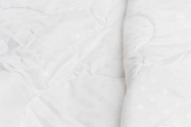 istock White fabric blanket close-up backdrop with selective focus and background blur 1226390101