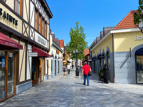 Roermond (designer outlet), Netherlands - May 19. 2020: View on exterior shopping street in summer with blue sky
