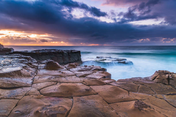 istock Rock Platfform, Rain Clouds and a Sunrise Seascape 1226390790