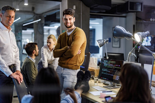 istock Group of happy programmers talking in the office. 1226391767