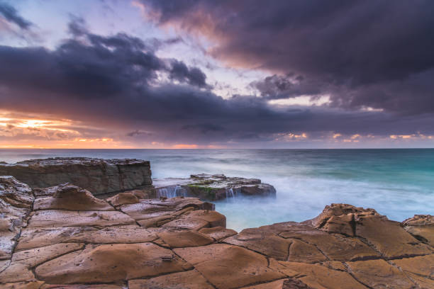 istock Rock Platfform, Rain Clouds and a Sunrise Seascape 1226392054