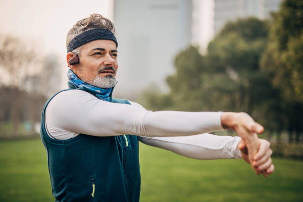 istock Handsome mature man stretching before jogging in public park 1226393054