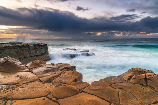 istock Rock Platfform, Rain Clouds and a Sunrise Seascape 1226393091
