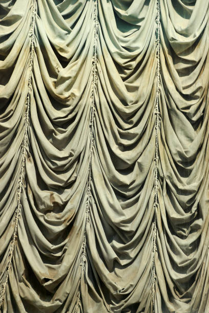 istock Old draped window, creased curtains behind dirty glass 1226395811
