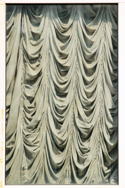 istock Old draped window, creased curtains behind dirty glass 1226395817