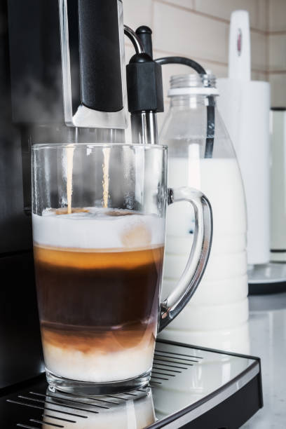 istock cup with hot cappuccino prepared in the coffee machine 1226396430