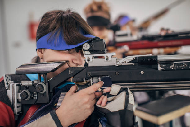istock Portrait of girl on rifle shooting training 1226398024