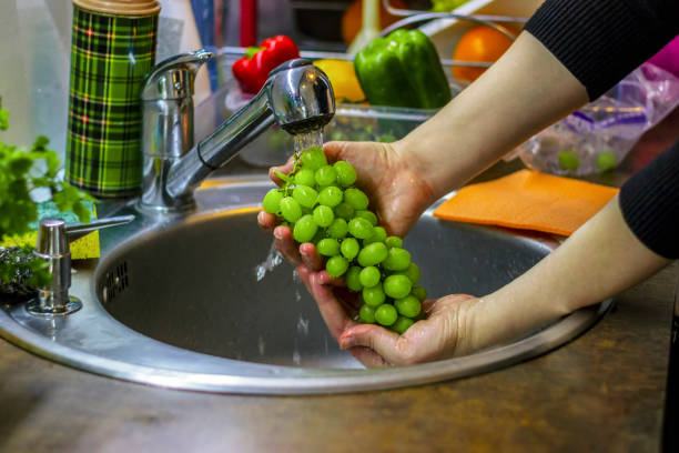 istock Washing fresh grapes in the kitchen. 1226398034