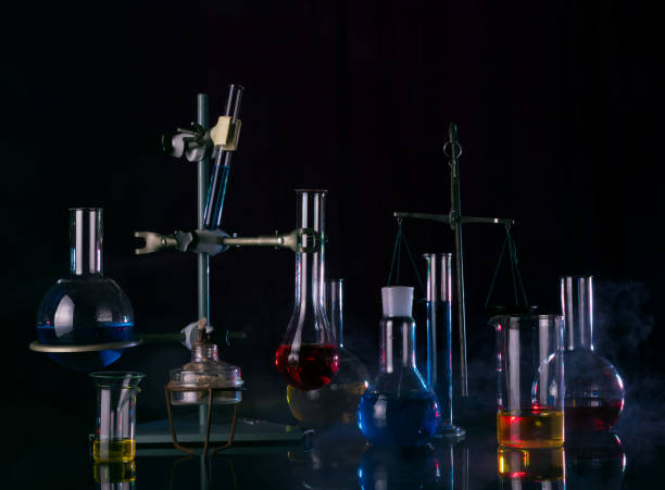 istock Test tubes, flasks, burner and other laboratory equipment in a smog on a black 1226398775