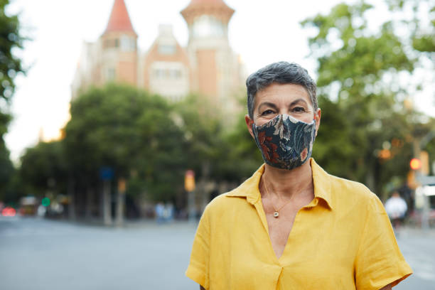 istock One person wearing a protective mask and smiling 1226400129