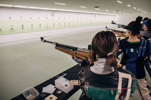 istock Group of girls on rifle shooting practice 1226400139
