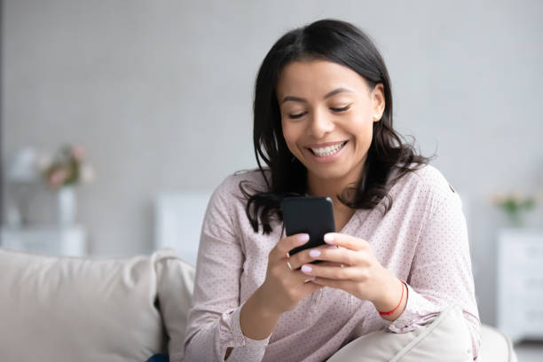 istock African woman resting on sofa use smartphone chatting with friend 1226400714