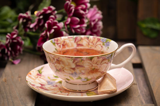 istock Pretty porcelain teacup with black tea 1226402003