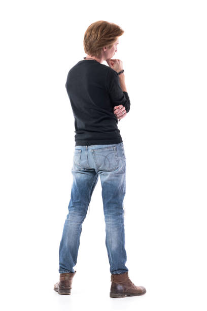 Back view of handsome young man watching interested at copy space with hand on chin. Back view of handsome young man watching interested at copy space with hand on chin. Full body length isolated on white background. full body isolated stock pictures, royalty-free photos & images