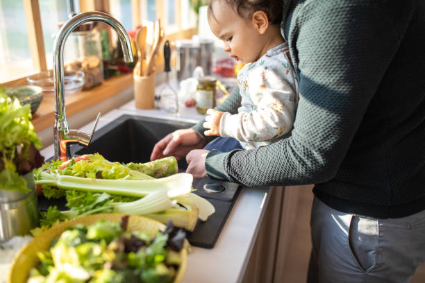 istock Father and son preparing healthy salad in kitchen together 1226403761