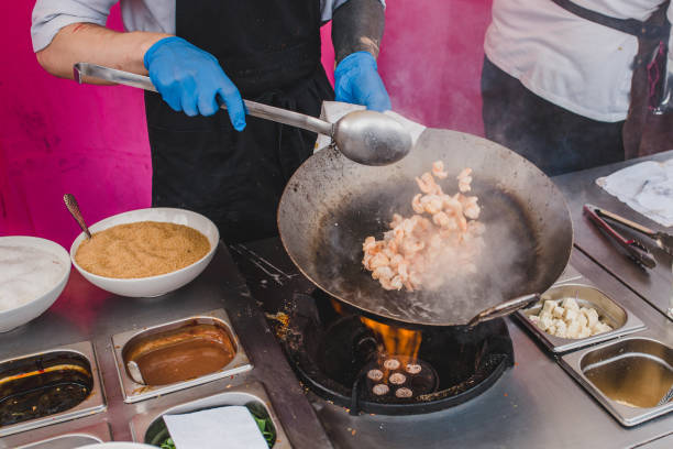 istock Chef tosses shrimps in a pan 1226404445