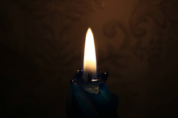istock Blue candle burning in the dark 1226407596