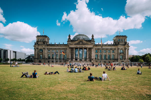 Reichstag in Berlin, Germany View of the German Parliament, called Der Reichstag. People are resting, lying on the meadow. bundestag photos stock pictures, royalty-free photos & images