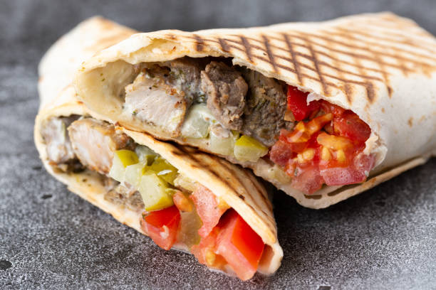 istock pork roll with tomato and pickled cucumbers. fried pita bread on a stone plate 1226408573