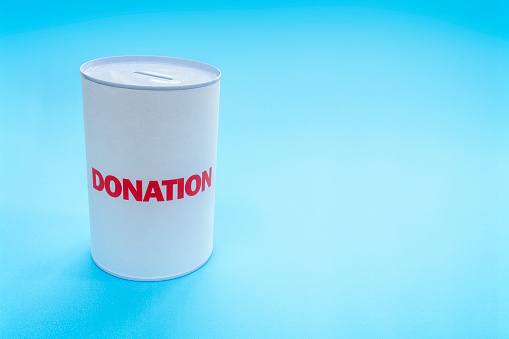 Collection for charity or business in donation box on blue background