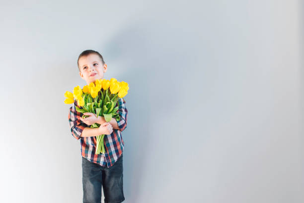 istock The boy holding flowers. 1226410482