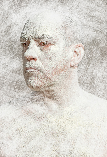Man with white dust on body side view