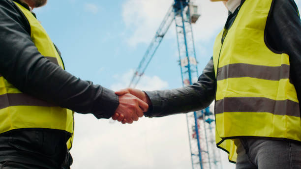 istock Construction builder making a deal with female engineer. Building site. Close up on hands 1226410745