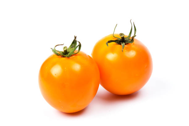 istock Yellow fresh tomatoes isolated on white background in close-up 1226411201