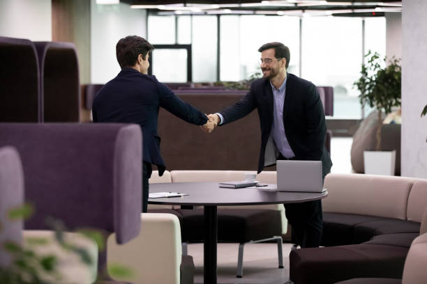 istock Two businessmen at meeting shake hands express respect 1226412431