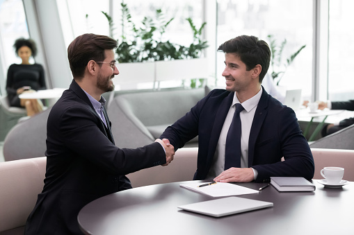 Business etiquette, greeting gesture, start meeting handshake as express of respect concept. Two businessmen in formal suits accomplish successful negotiations, succeed goal, sign contract, make deal