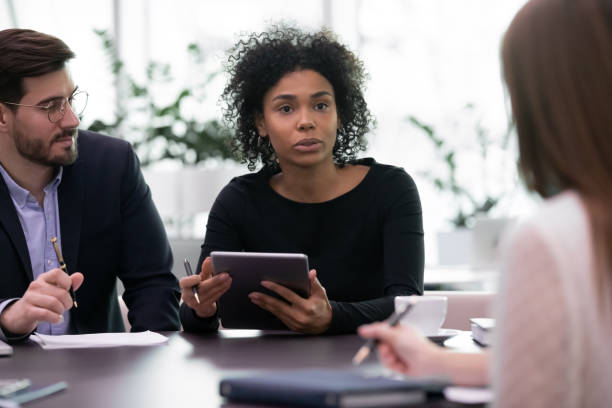 istock Multiethnic partners gathered in boardroom to negotiate solve current issues 1226412445