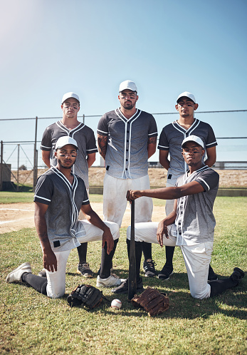 Portrait of a group of confident young men playing a game of baseball