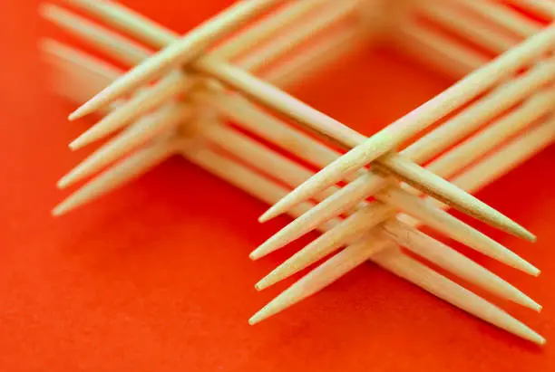 Photo of Arranged toothpicks on red background