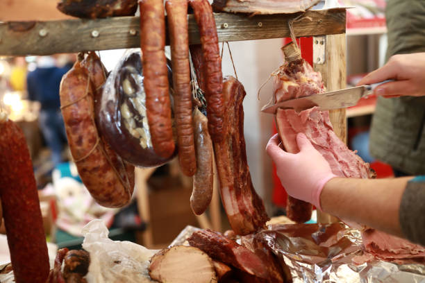 istock Seller cuts slice of ham 1226413223