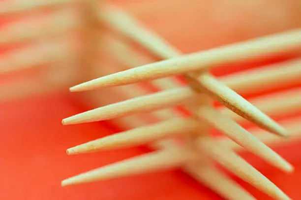 Photo of Arranged toothpicks on red background