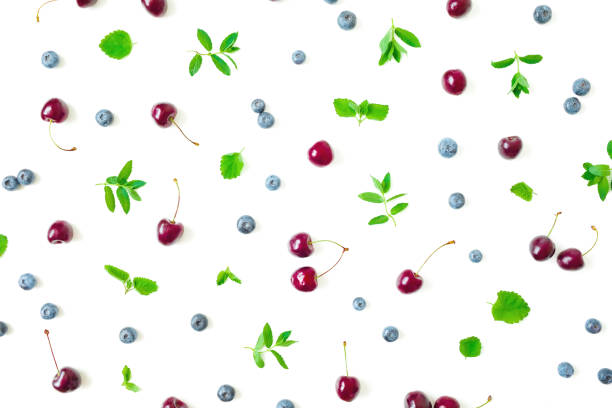 istock Blueberries and cherry with mint leaves on white background. Top view. Flat lay 1226414382