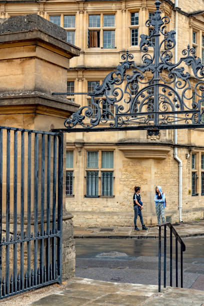 The footpath beside New College with  student chatting. Oxford, Oxfordshire, England, UK.