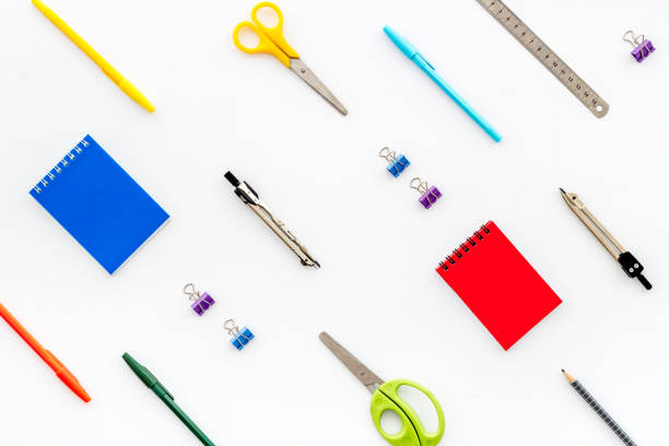 istock School supplies pattern - notebook, pen, ruler, sciccors - on white table top-down 1226416983