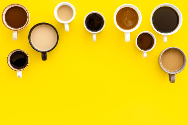 istock Coffee addiction. Many of cups on yellow table top view space for text 1226418241