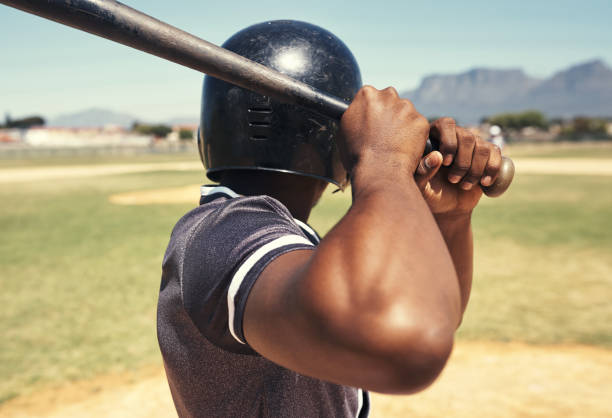 When life throws you a ball you better be ready Shot of a young man swinging his bat at a baseball game home run photos stock pictures, royalty-free photos & images