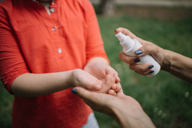 istock Cropped people disinfecting hands with antiseptic spray 1226421141
