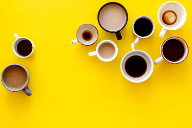 istock Different cups of coffee on yellow table top-down space for text 1226421855