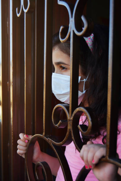 A girl isolated at home standing at the door stock photo