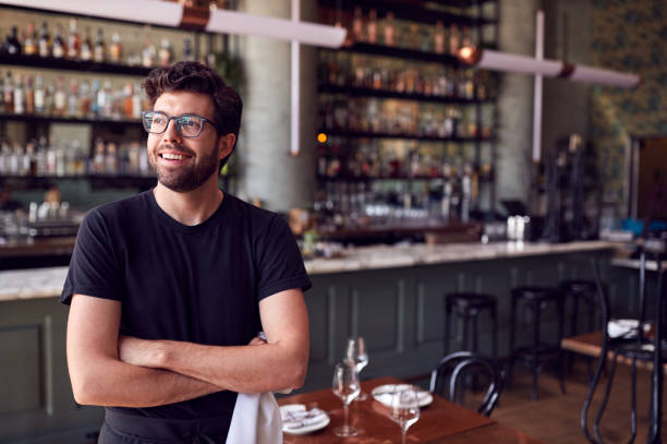 istock Male Waiter Standing In Bar Restaurant Before Service 1226423638