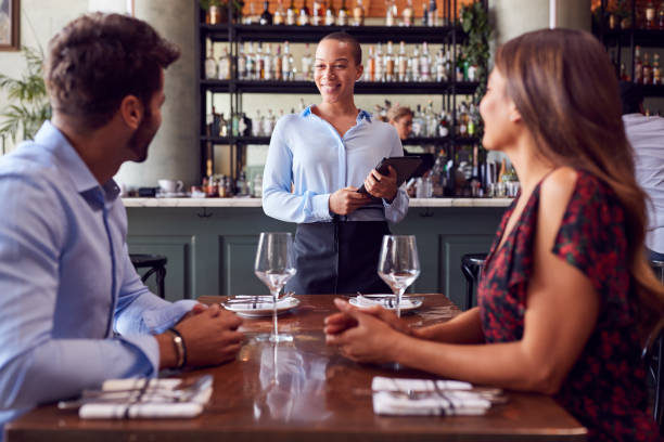 istock Female Waitress With Digital Tablet Taking Order From Romantic Couple Sitting At Restaurant Table 1226424675