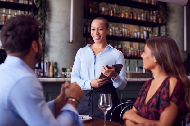 istock Female Waitress With Digital Tablet Taking Order From Romantic Couple Sitting At Restaurant Table 1226424694