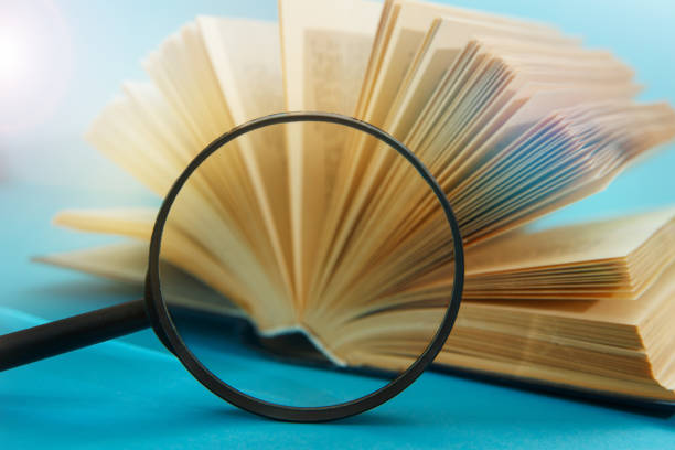 Stack book with magnifying glass stock photo