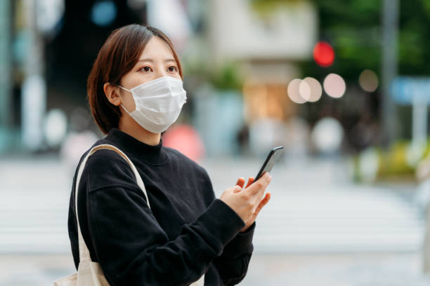istock Young woman using mobile phone in city 1226427498