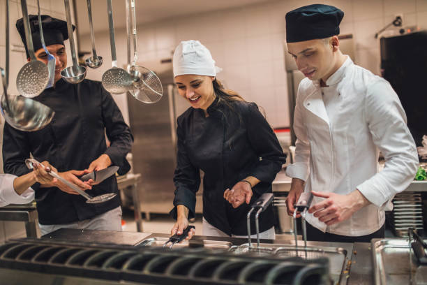 istock The team of cooks backs in the work in the modern kitchen, 1226427817
